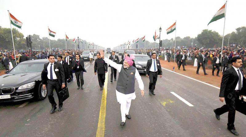 Prime Minister Narendra Modi greets the crowd as he leaves after the 68th Republic Day parade at Rajpath in New Delhi on Thursday.  This is the second time Modi walked down the Rajpath breaking away from tradition. (Photo: PTI)