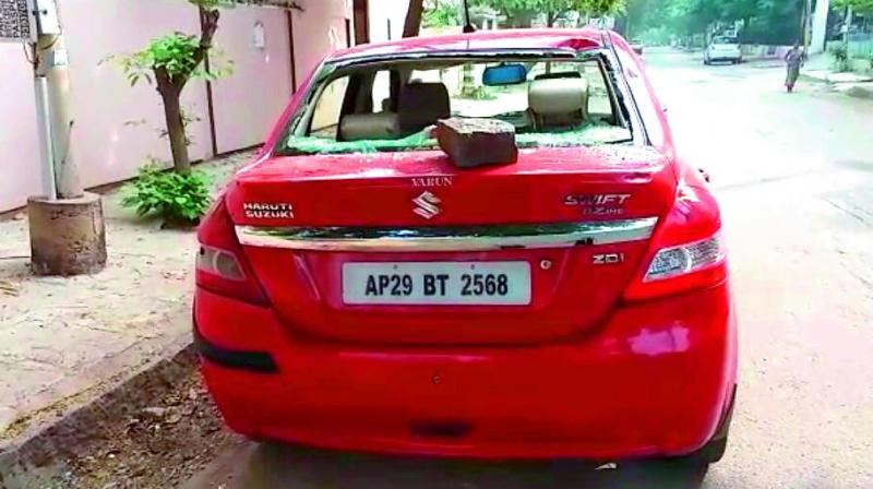 One of the cars damaged by vandals in the wee hours of Thursday in Srilakshmi Colony. (Photo: DC)