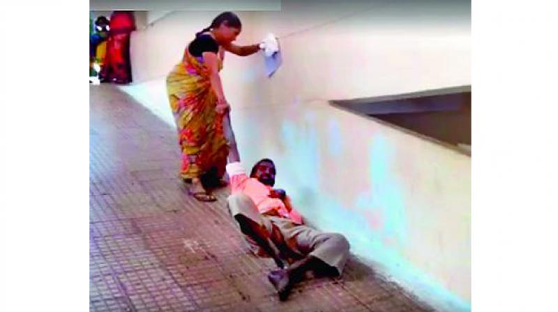 A video grab of P. Srinivasacharis wife dragging him up the stairs of APVP Hospital in Guntakal. 	(Photo: DC)