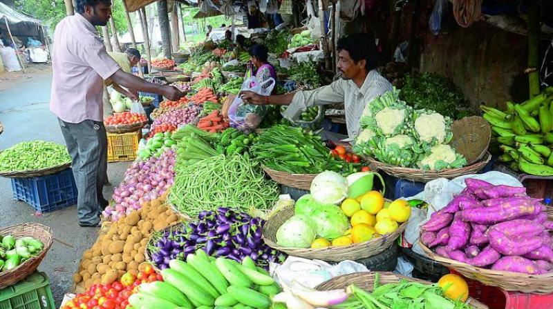 Vendors at the otherwise busy Kaleswara Rao vegetable market in Vijaywaada wait for customers on Thursday.