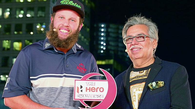 Andrew Johnston gets his Hero Challenge trophy from Hero MotoCorp CMD and CEO Pawan Munjal.