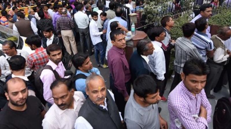 People standing in long queues to exchange their old Rs 500 and 1000 notes and withdraw cash from the ATM. (Representational Image/ PTI)