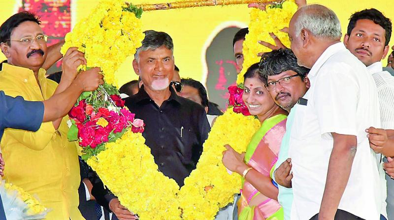 TD activists felicitate Chief Minister N. Chandrababu Naidu at the IGMC stadium in Vijayawada on Sunday. Naidu is wearing a black shirt in protest against the Central government neglecting funds to Andhra Pradesh.