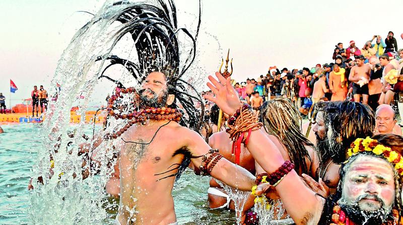 Devotees taking a dip into the holy water during the ongoing Kumbh Mela.