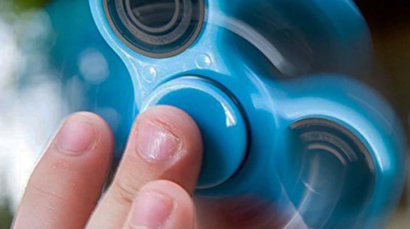Your children probably dont need to be told that the fidget spinner is a small toy of metal and plastic usually with three blades with a spinning wheel in the centre.