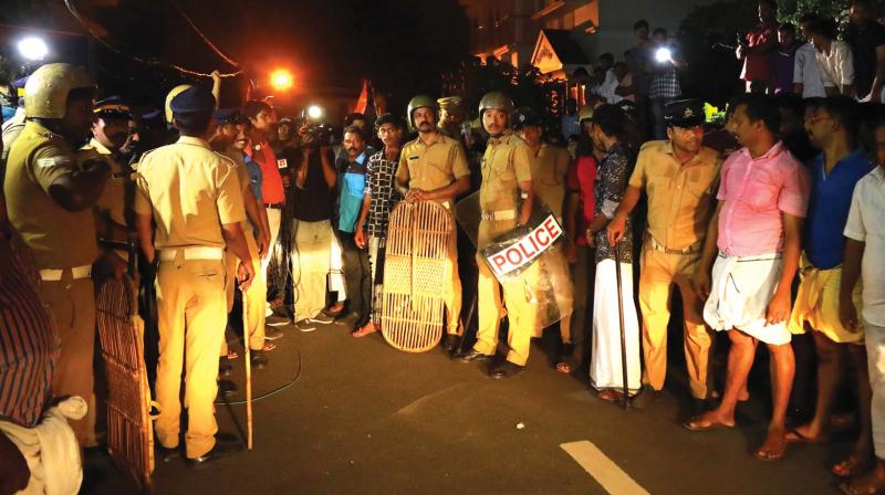 A pose of police and mediamen, along with local residents, waits at the Aluva police Club for Dileep to arrive. (Photo: Arunchandra Bose)