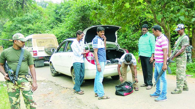 Armed police personnel inspect the vehicles near Sileru during the ongoing combing operations against Maoists in Visakhapatnam Agency on Thursday. (DC)
