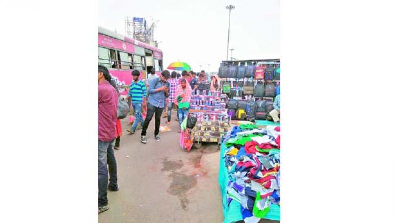 Bus stop at Regimental Bazaar crowded with vendors  leaving no space for pedestrians.