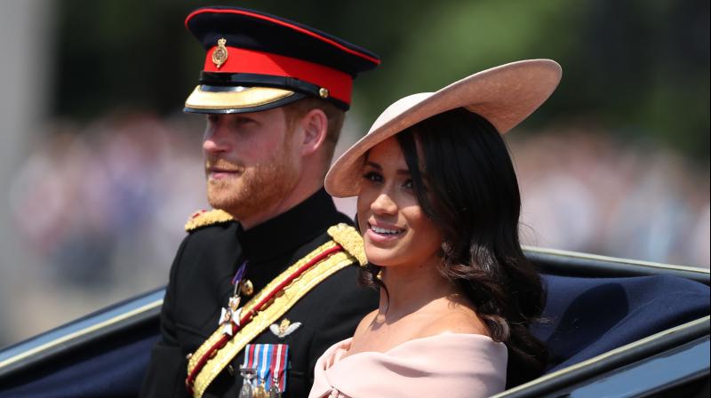 Britains Prince Harry, Duke of Sussex and Britains Meghan, Duchess of Sussex return in a horse-drawn carriage after attending the Queens Birthday Parade, Trooping the Colour on Horseguards parade in London on June 9, 2018. (Photo: AFP)