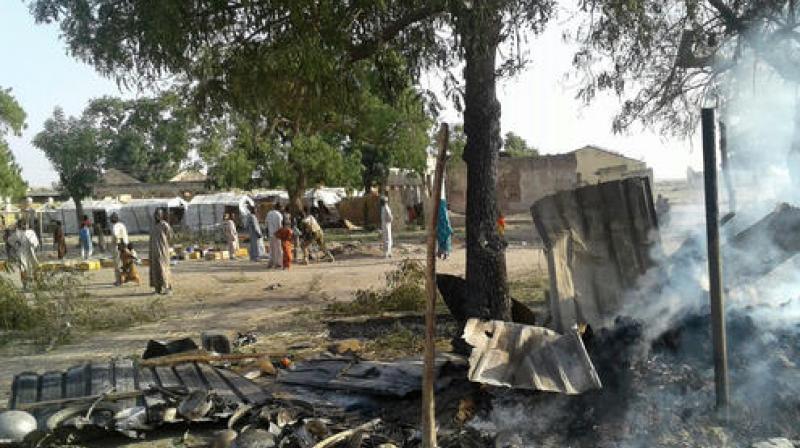 In this image supplied by MSF, smoke rises from a burnt out shelter at a camp for displaced people in Rann. (Photo: AP)