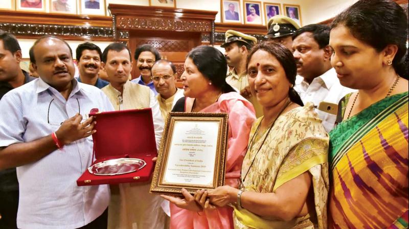 CM H.D. Kumaraswamy and Minister Jayamala with the Centres award given to Karnataka State Women Development Corporation, in Bengaluru on Thursday 	 DC