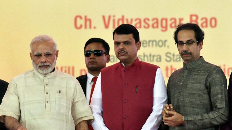 Prime Minister Narendra Modi alongwith, Maharashtra CM Devendra Fadnavis and Shiv Sena President Uddhav Thackarey. (Photo: PTI)