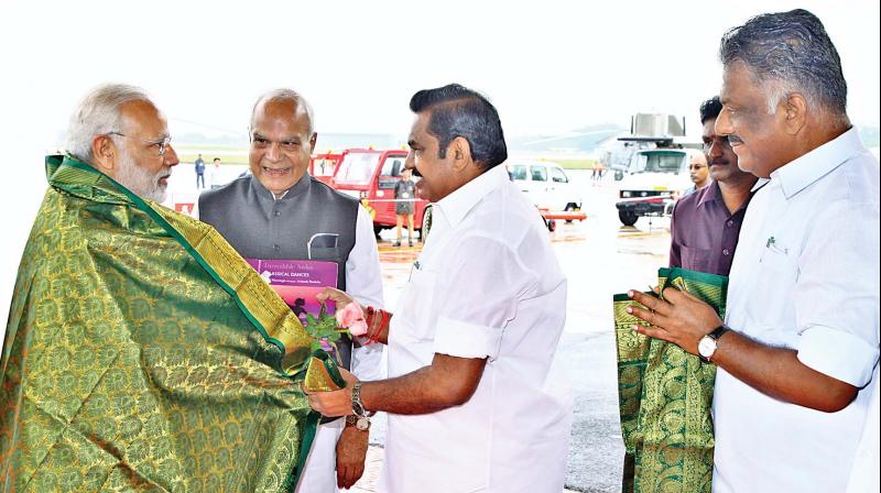 Tamil Nadu Chief Minister Edappadi K. Palaniswami welcomes Prime Minister Narendra Modi at Chennai Airport on Monday. Tamil Nadu Deputy Chief Minister O. Panneerselvam and TN Governor Banwarilal Purohit were also present. (Photo: DC)