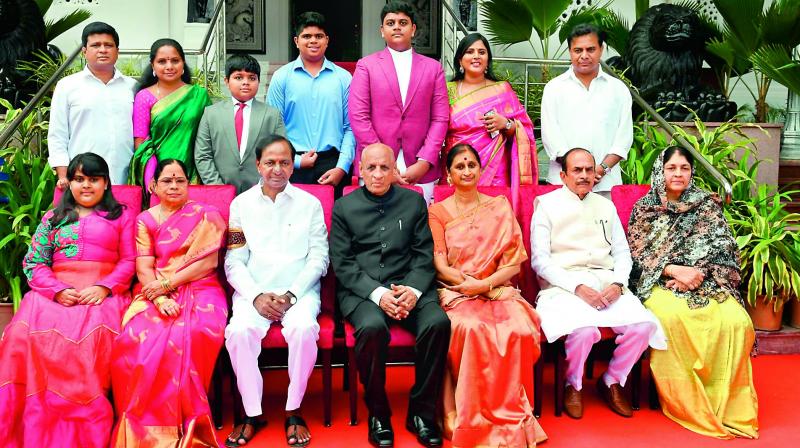 Governor E.S.L. Narasimhan and his wife Vimala pose for a photograph with Chief Minister K. Chandrasekhar Rao and his wife Shobha, and minister Mahmood Ali and his wife Nasreen Fathima (sitting extreme right) after the swearing-in ceremony at Raj Bhavan in Hyderabad on Thursday. Others in the photo are from right: former minister K.T. Rama Rao, his wife Shailima Rao, their son Himanshu. Their daughter Alekhya is sitting extreme left. TRS MP K. Kavitha is seen with her husband Dr Anil Kumar (standing extreme left) and their sons Aditya and Aarya.daughter Alekhya (sitting extreme left);