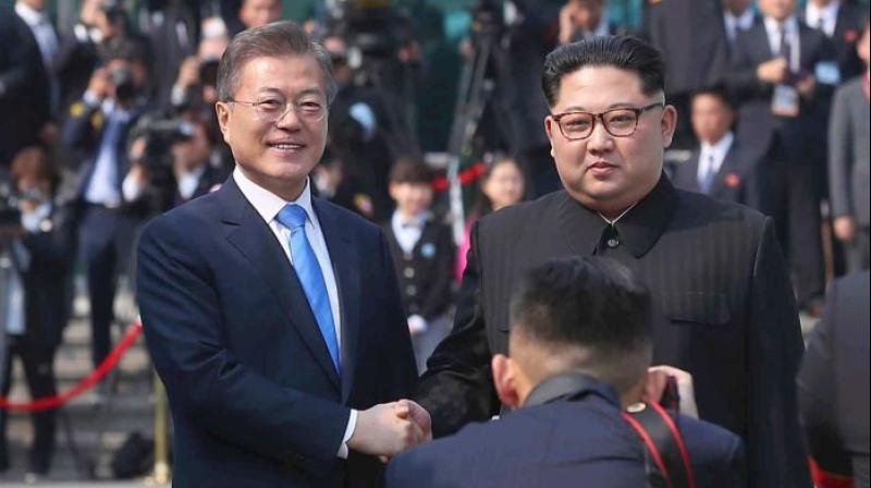 After shaking hands over the Military Demarcation Line dividing the two Koreas, Kim (R) stepped over -- making him the first North Korean leader to enter the South since the Korean War ended in armistice 65 years ago. (Photo: AP)