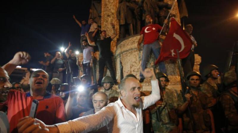 Supporters of Turkeys President Recep Tayyip Erdogan protest in front of soldiers in Istanbuls Taksim square. (Photo: AP)