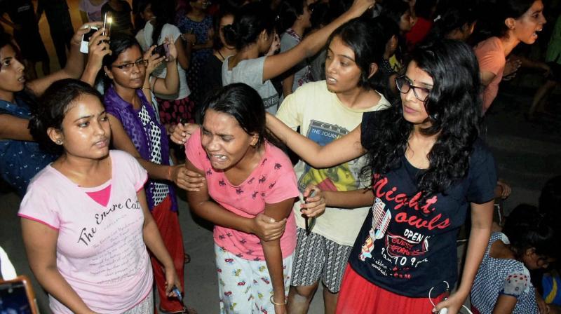 An injured student writhing in pain after police allegedly beat them up during a clash at Banaras Hindu University late Saturday night. (Photo: PTI)
