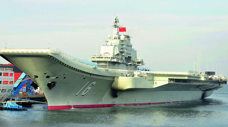 Chinas first aircraft carrier, Liaoning, and five naval warships passed by Taiwan and sailed into the contested South China Sea on Monday. (Photo: AP)