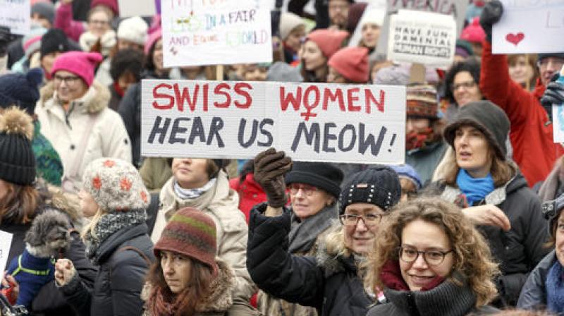 Protesters hold placards with slogans, during the Womens March rally, in Geneva, Switzerland. (Photo: AP)