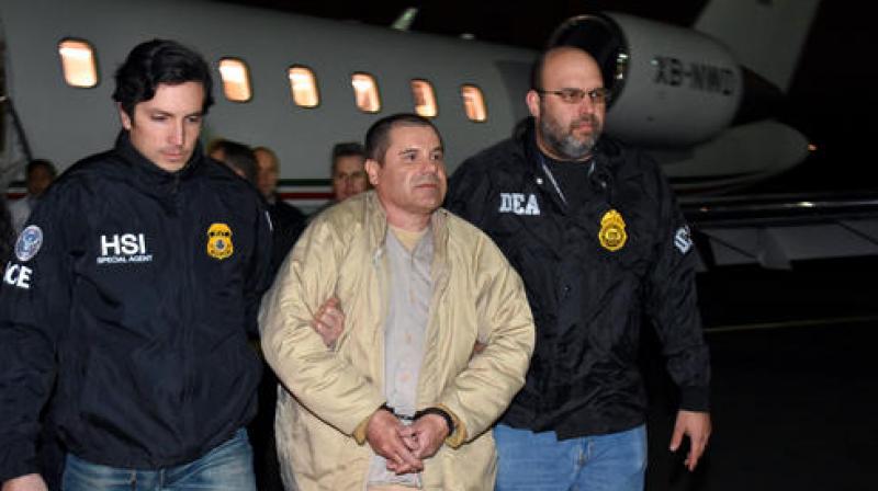 Authorities escort Joaquin El Chapo Guzman from a plane to a waiting caravan of SUVs at Long Island MacArthur Airport on Thursday. (Photo: AP)