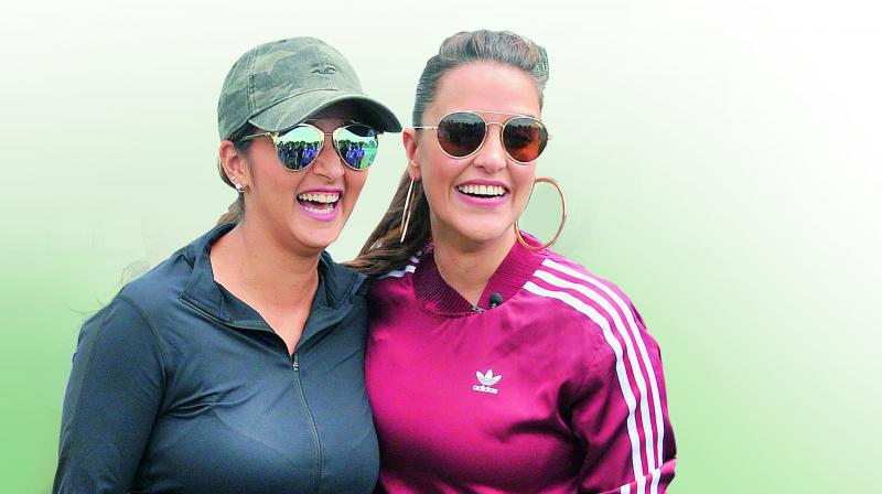 Sania Mirza and Neha Dhupia share a light moment at the formers tennis academy on the outskirts of Hyderabad during the WTA Future Stars clinic on Tuesday. (Photo: P. Surendra)