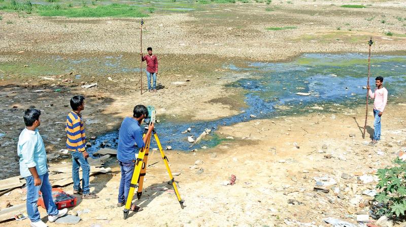 Public Works Department officials take up desilting works in Korattur lake on Tuesday. (Photo: DC)