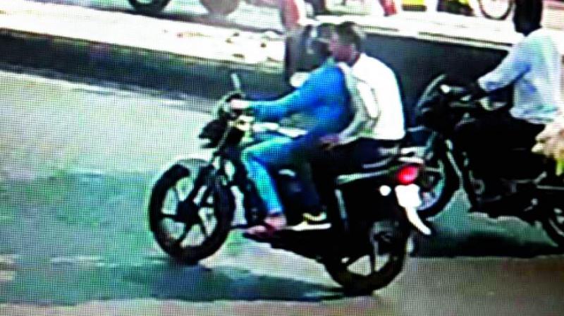 The CCTV image released by police shows the two chain-snatchers riding a bike through Kukatpally on Thursday.