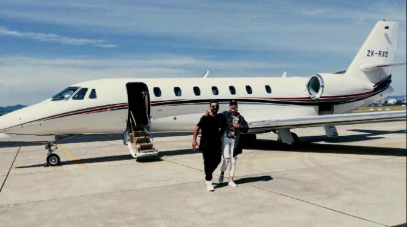 Virat and Anushka pose in front of their private jet