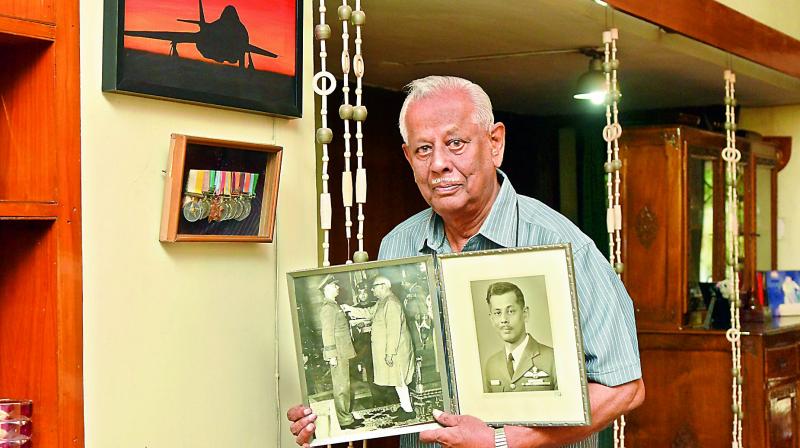 Air Vice Marshal C.V. Parker (Retd.), holds a picture of the president conferring him the Maha Vir Chakra award in January 1972. In the backdrop are his medals and a picture of the hunter aircraft, he flew when he attacked Pakistans deepest air-base in Peshawar. (Photo: DC)
