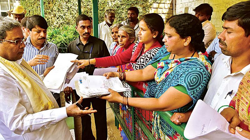 CM Siddaramaiah receives petitions during the Janata Darshan progaramme in Bengaluru on Monday. (Photo: KPN)