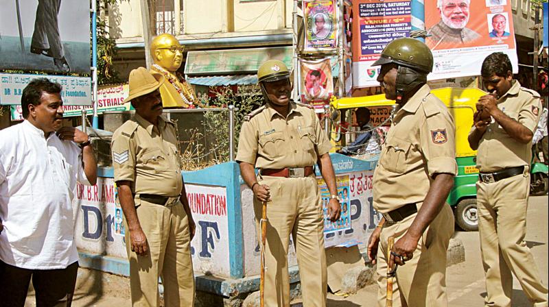 The police stand guard at Srirampura, one of the Tamil-dominated areas in Bengaluru, on Monday. (Photo: DC)