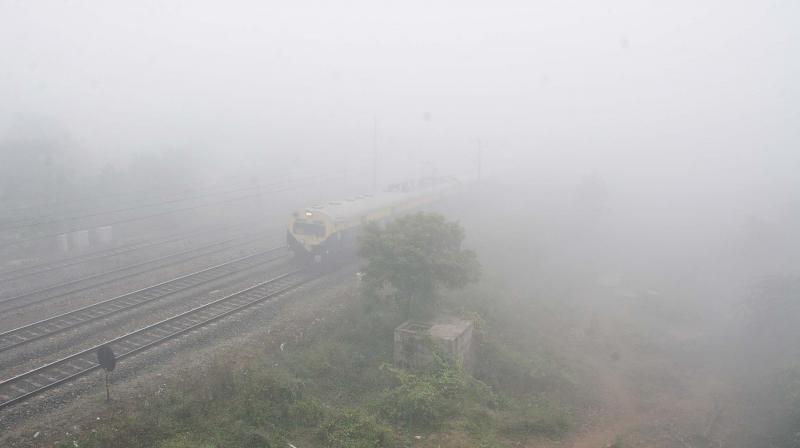 A local train in Villivakkam gets camouflaged in smog making it barely visible. (Photo: DC)