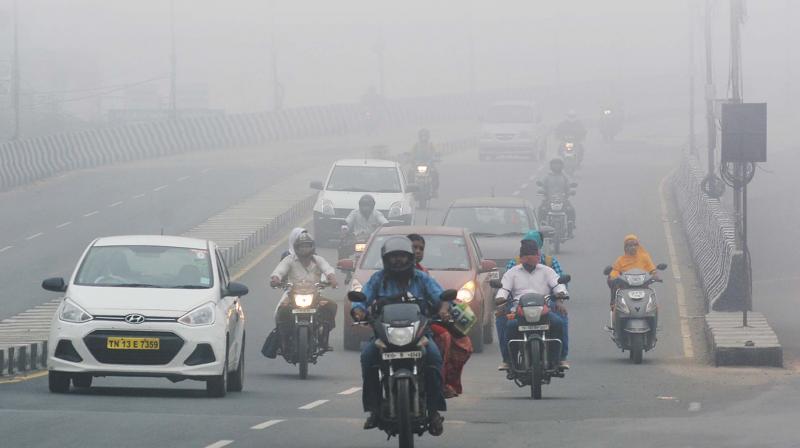 Motorists ride through smog on Tambaram flyover on Saturday. (Photo: DC)