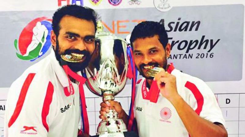 Indian hockey team captain P.R. Sreejesh (left) and Birender Lakra with the Asian Champions trophy.