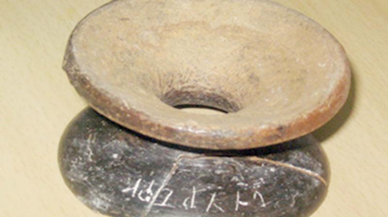 The Tamil Brahmi script in the terracotta weight holder retrieved during a exploration at Thadagam in Coimbatore. (Photo: DC)