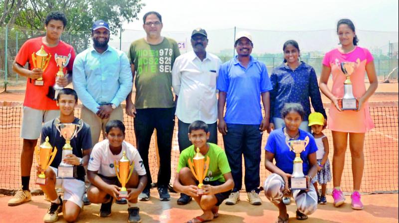 Winners and runners-up of the Open AITA Championship Series All India Ranking tennis tournament played at Carnival Club in Sainikpuri, Secunderabad, are all smiles as they pose with their trophies.