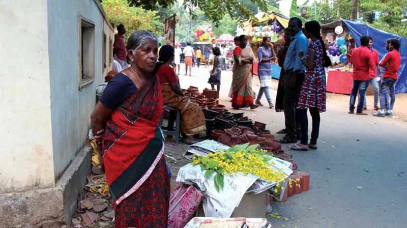 An elderly woman waits for customers to sell Kanikonna on Thursday.