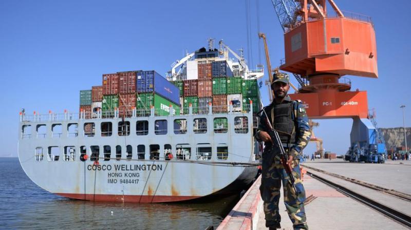 Pakistani Naval personnel stand guard near a ship carrying containers at the Gwadar port, some 700 kms west of Karachi. (Photo: AFP)