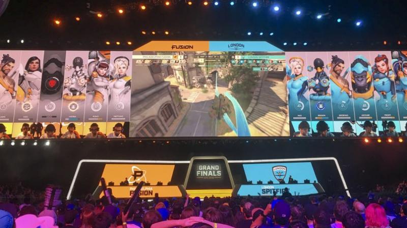 Fans watch the Philadelphia Fusion and London Spitfire compete in the Overwatch League Grand Finals first night of competition at the Barclays Center in the Brooklyn borough of New York. (AP Photo/Terrin Waack)