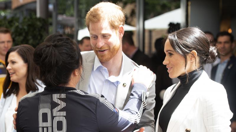 Meghan, Duchess of Sussex, watches her husband Britains Prince Harry speaks during a lunchtime reception hosted by Australian Prime Minister Scott Morrison with Invictus Games competitors, their families and friends in Sydney Sunday, Oct. 21, 2018. (Photo: AP)
