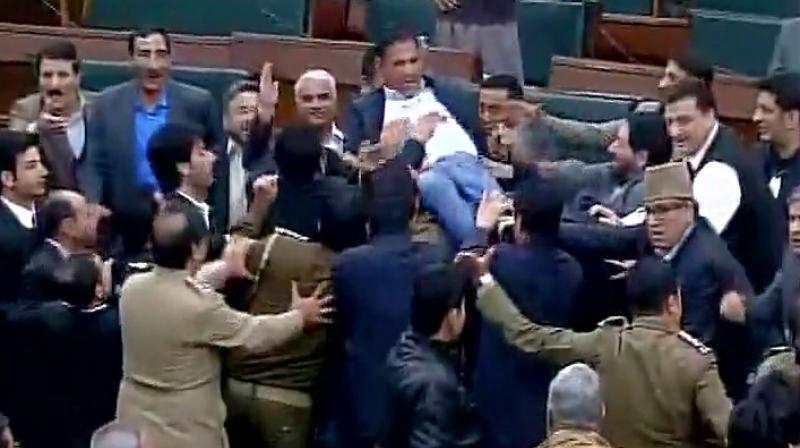 Some of the members were seen protesting on the tables and furniture and mikes were uprooted during the protests. (Photo: Twitter/ANI)