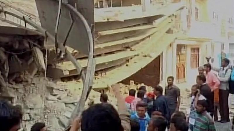 The incident took place in KDA (Kanpur Development Authority) colony in the afternoon, when top floors of the seven-storey under-construction building started falling. (Photo: Twitter/ANI)