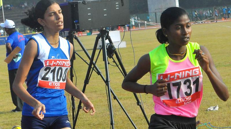 C. Babitha leads in the senior girls 1,500m race ahead of Usha Schools Abitha Mary Manuel.