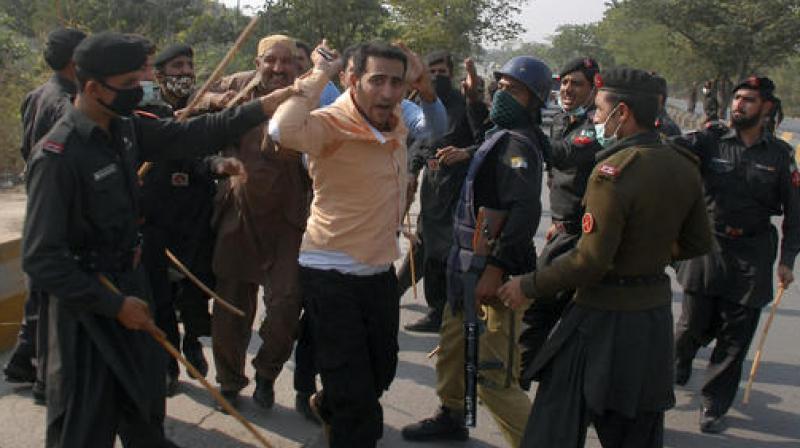 Pakistani security officers arrest supporters of opposition politician Imran Khan who were trying to reach Khans house, in Islamabad, Pakistan. (Photo: AP)