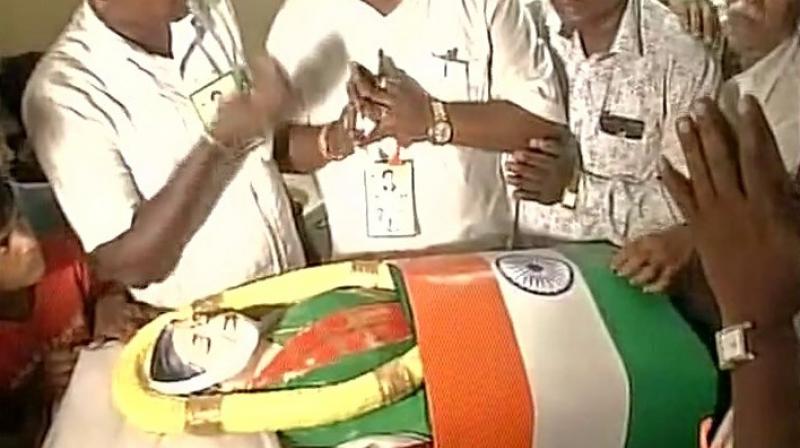 A replica of a coffin with late Tamil Nadu chief minister Jayalalithaas figurine (Photo: ANI Twitter)