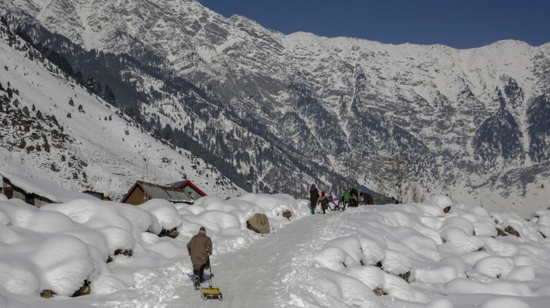 Children play with sleds on a snow covered slope near Gund, about 80 kilometers north of Srinagar. (Photo: AP)