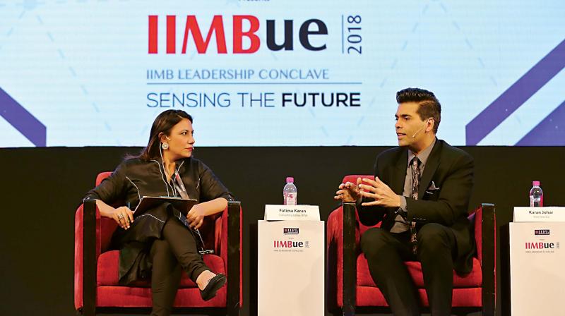 Filmaker Karan Johar with a moderator at IIM Alumni Associations IIMBue Leadership Conclave in Bengaluru on Friday (Photo: DC)