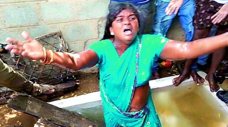 A woman in tears after her house was demolished.