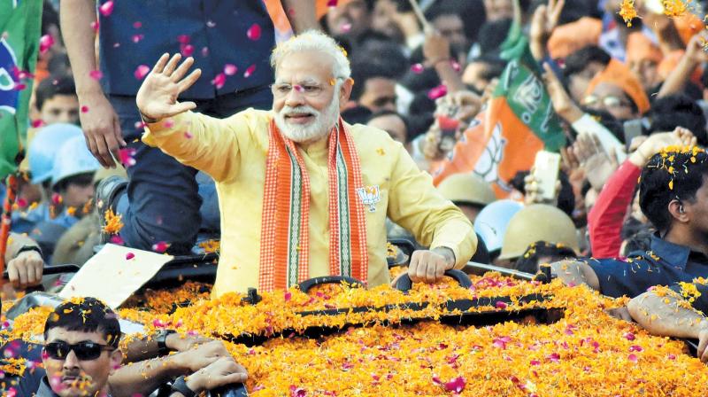 Prime Minister Narendra Modi at a road show in Varanasi during the Uttar Pradesh Assembly election campaign. (Photo: PTI)