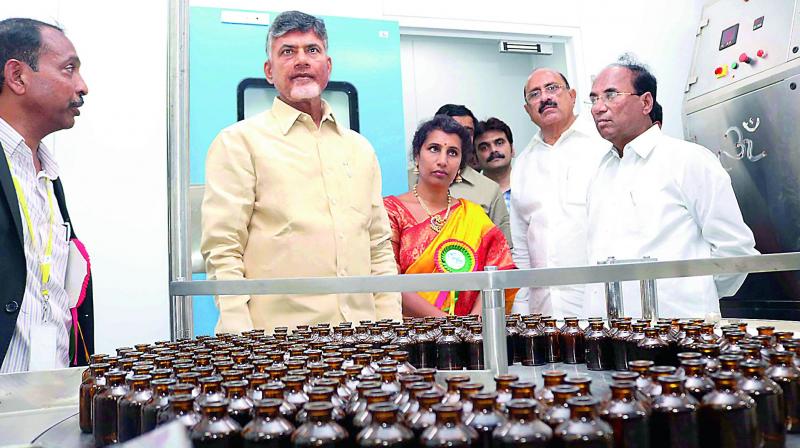 Chief Minister N. Chandrababu Naidu, Speaker Kodela Sivaprasada Rao, minister for health Kamineni Srinivas watch the Safe Parental Limited Company after its inauguration at Mulakaluru village in Guntur district on Saturday. (Photo: DC)